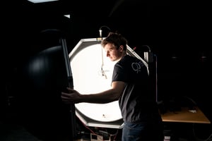 _   Engineer testing a flat-panel display in a photometric laboratory using an integrating sphere
